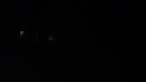 Closeup of a big light bulb being turned on in a dark room Stock Footage 140066824