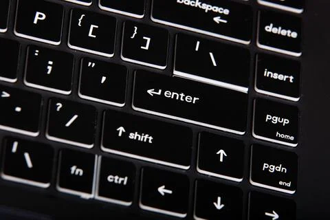 Closeup of a black computer keyboard with white letters and numbers on it Stock Photos