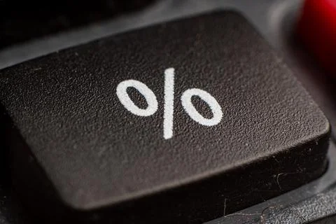 Closeup of a black electronic keypad button representing percentage for Stock Photos