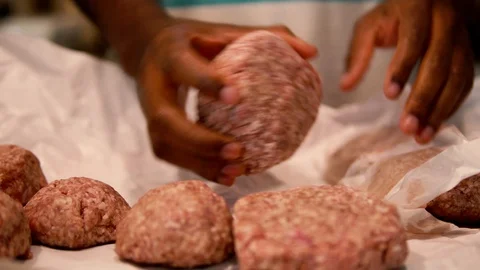 Closeup, Black hands mold raw ground beef into a hamburger patty Video stock 92605003