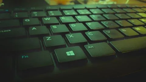 Closeup of a black keyboard with illuminated keys Green RGB Stock Photos
