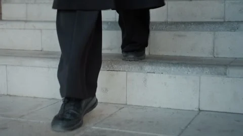 Closeup black shoe stepping down concrete stairs Stock Footage 321480395