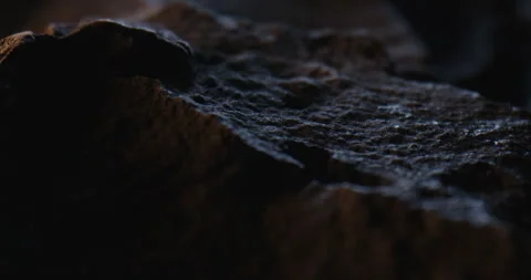 Closeup of Black Stone Surface Texture with Slow Probe Lens Push-In 動画素材 348705886