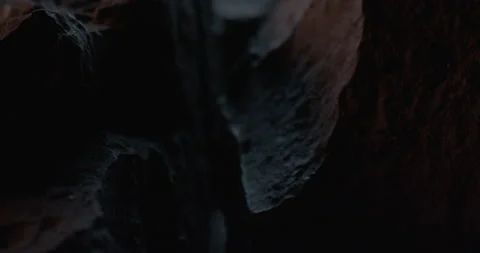 Closeup of Black Stone Surface Texture with Slow Probe Lens Push-In 動画素材 348706702