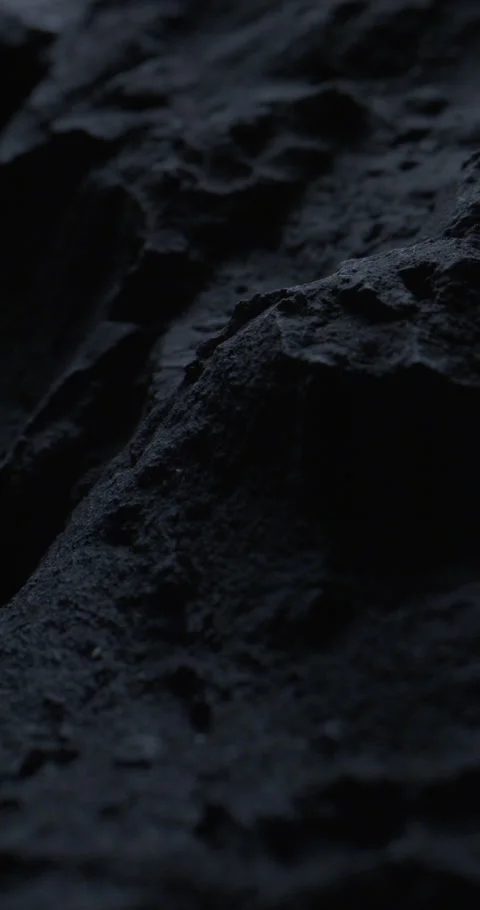 Closeup of Black Stone Surface Texture with Slow Probe Lens Push-In. 動画素材 348755650