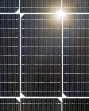 Closeup black  surface of solar panel with sunlight. Stock Photos