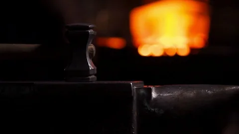 Closeup of a blacksmith's hammer on the background of burning flames of the Video stock 89685251