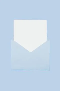 Closeup on blank empty white paper card in blue opened envelope isolated on blue Stock Photos