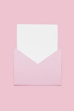 Closeup on blank empty white paper card in pink opened envelope isolated on pink Stock Photos