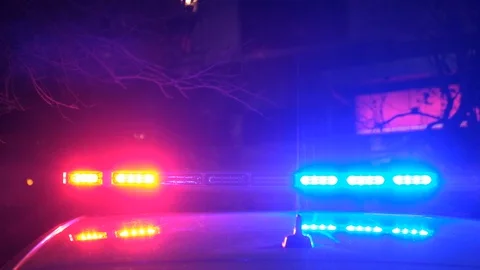 Closeup of blue and red light flasher atop of a police car at night. Stock Footage 129280875