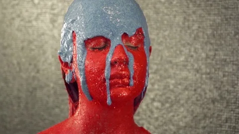 Closeup of blue color is pouring down the girl's face slow motion Stock Footage 73668995