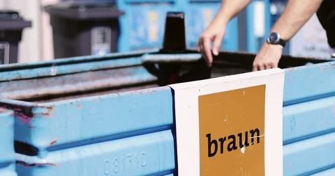 Closeup of a blue container with trash for glass. A man is sorting garbage. Stock Footage 103631989