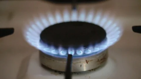 Closeup of blue flame coming out of vintage natural gas stove burner. Stock Footage