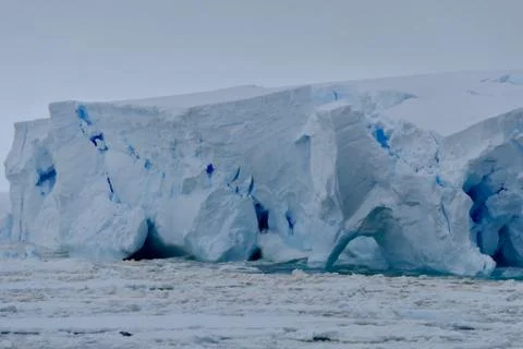 Closeup of blue iceberg at edge of pack ice in antarctic ocean, Antarctica Stock Photos