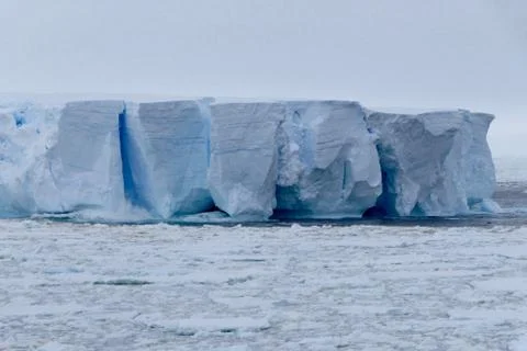 Closeup of blue iceberg at edge of pack ice in antarctic ocean, Antarctica Stock Photos
