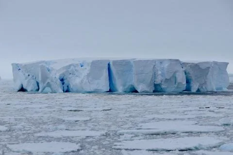 Closeup of blue iceberg at edge of pack ice in antarctic ocean, Antarctica Stock Photos