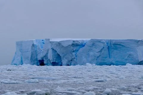 Closeup of blue iceberg at edge of pack ice in antarctic ocean, Antarctica Stock Photos