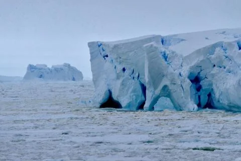 Closeup of blue iceberg at edge of pack ice in antarctic ocean, Antarctica Stock Photos