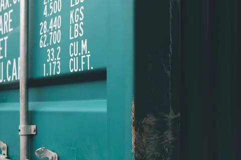 Closeup of a blue intermodal container with weights mentioned in kgs and lbs. Stock Photos