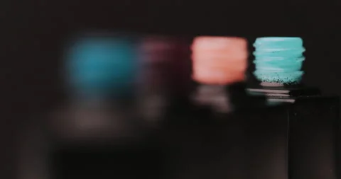 Closeup of blue, red, pink, turquoise nail polish with an open bottle Stock Footage 149368652
