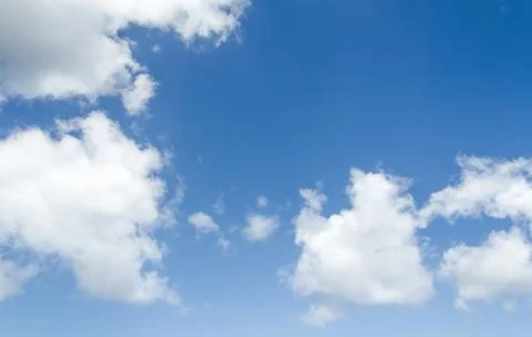 Closeup of blue sky with white clouds Stock Photos
