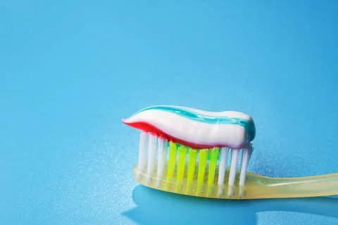 Closeup of blue toothbrush with toothpaste Stock Photos