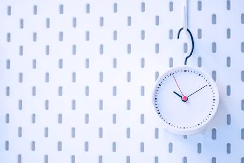 Closeup blue wall clock set on blue background Foto stock