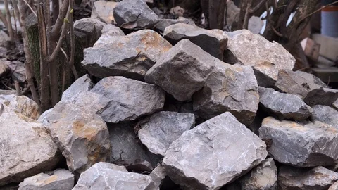 Closeup of blurry gray and white stones of various shapes. From above 3 stones Stock Footage 126650845