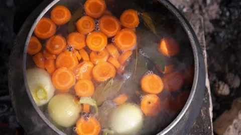 Closeup Boiling Fish and Vegetable Soup in Pot on Fire Outdoors Video stock 65284576