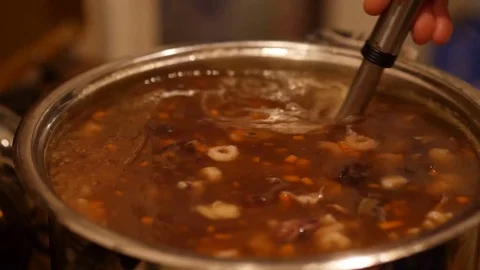 Closeup of a boiling hot chinese soup with shrimps and eggs. 60 to 24fps UHD 4K Видео 74344112