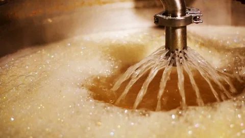 Closeup boiling hot liquid filtering during beer brewing process. Stock Footage 97285210