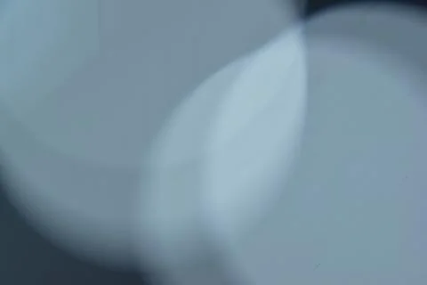 Closeup of bokeh lights on the solid dusty blue background Stock Photos