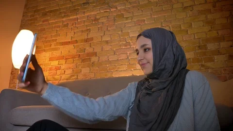 Closeup bottom up shoot of young attractive muslim female teenager taking Video stock 106087552