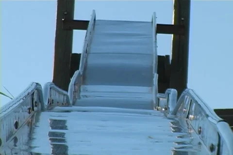 Closeup to bottom of a very long slide at a children's playground Stock Footage 565527