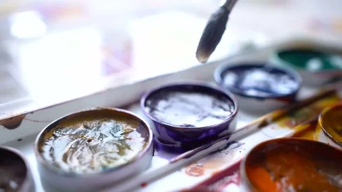 Closeup box of diffirents colors paint. Brush dipped in paint. Artist, stutent Stock Footage 70637535
