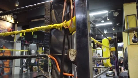 Closeup of boxing ring ropes and punching bag in gym training space Stock Footage 333819626