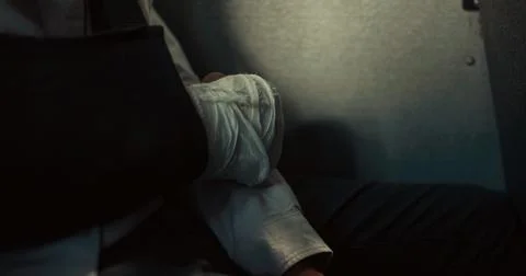 Closeup boy broken arm wrapped in plaster cast. Teenager sitting schoolbus. Stock Photos
