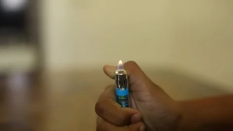 Closeup of a boy playing with fire, Lighter Stock Footage 129948324
