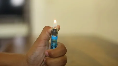 Closeup of a boy playing with fire, Lighter Stock Footage 129948494