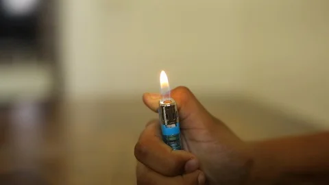Closeup of a boy playing with fire, Lighter Stock Footage 129948552