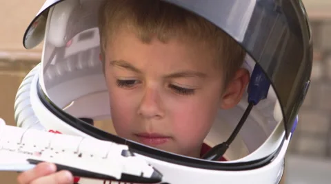 Closeup of boy playing with toy shuttle Stock Footage 67347344