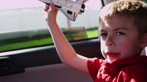 Closeup of boy playing with toy shuttle Stock Footage 67347667
