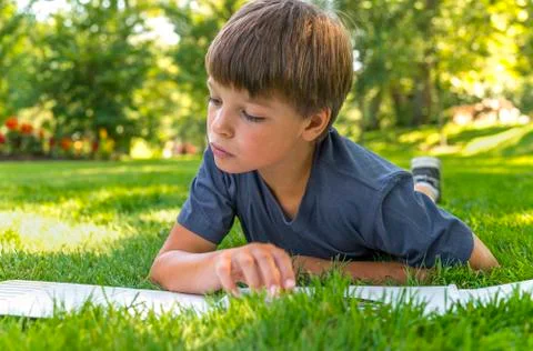 Closeup of a boy reading a book Stock Photos