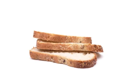 Closeup of bread slices rotating on the turntable. Isolated on white background. Vídeo Stock 157039918