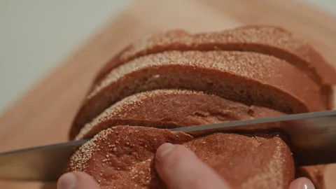 Closeup of bread slicing. Detailed view of crust and crumb during slicing Stock Footage 342066299