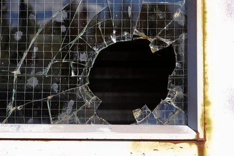 Closeup of a break-in through a wired glass window Stock Photos