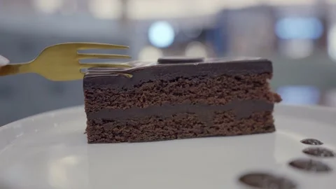 Closeup breaks of a piece of chocolate cake on a fork Stock Footage 168578418