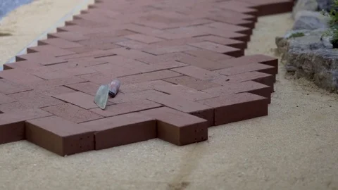 Closeup of the brick paving project showing the bricks in a herringbone pattern Stock Footage 82096229