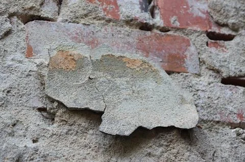 Closeup of brick wall with fallen plaster Stock Photos