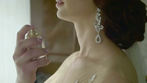 Closeup of a bride using perfume on her wedding day Stock Footage 70256544